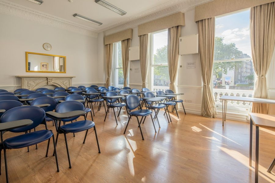 Foundation House classroom with a period fireplace and tall windows