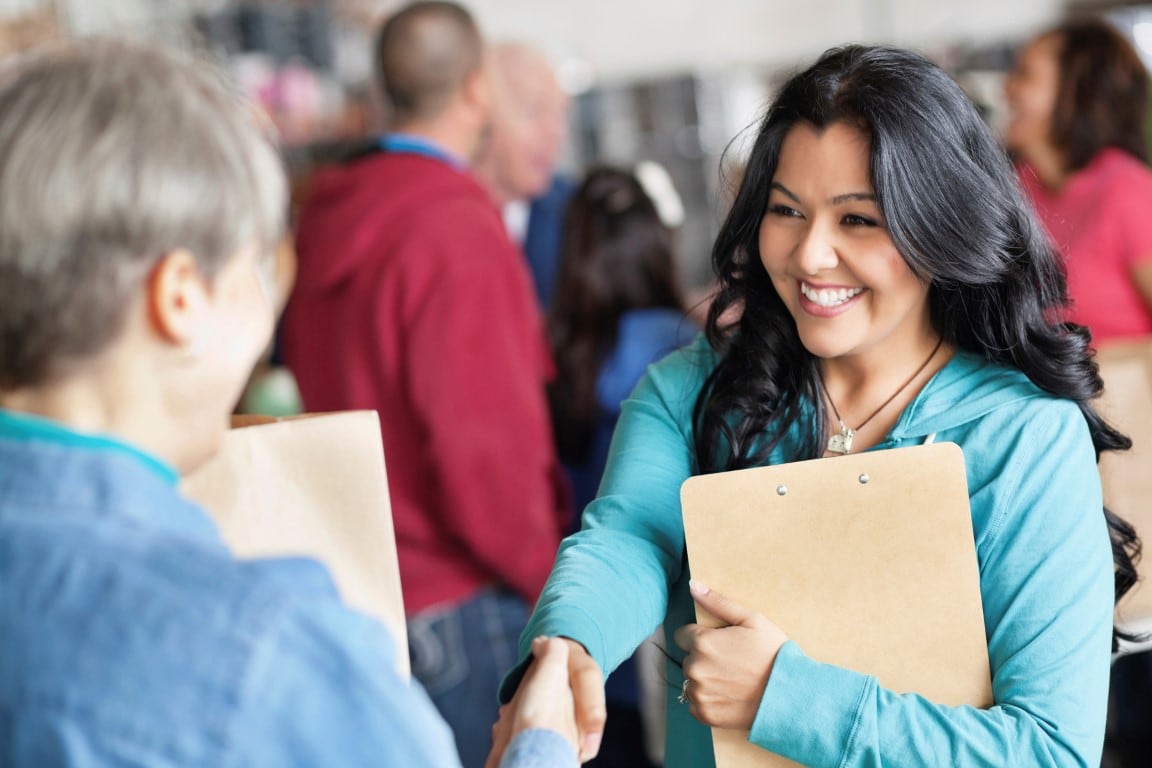 Internship Female volunteer greeting woman Medium